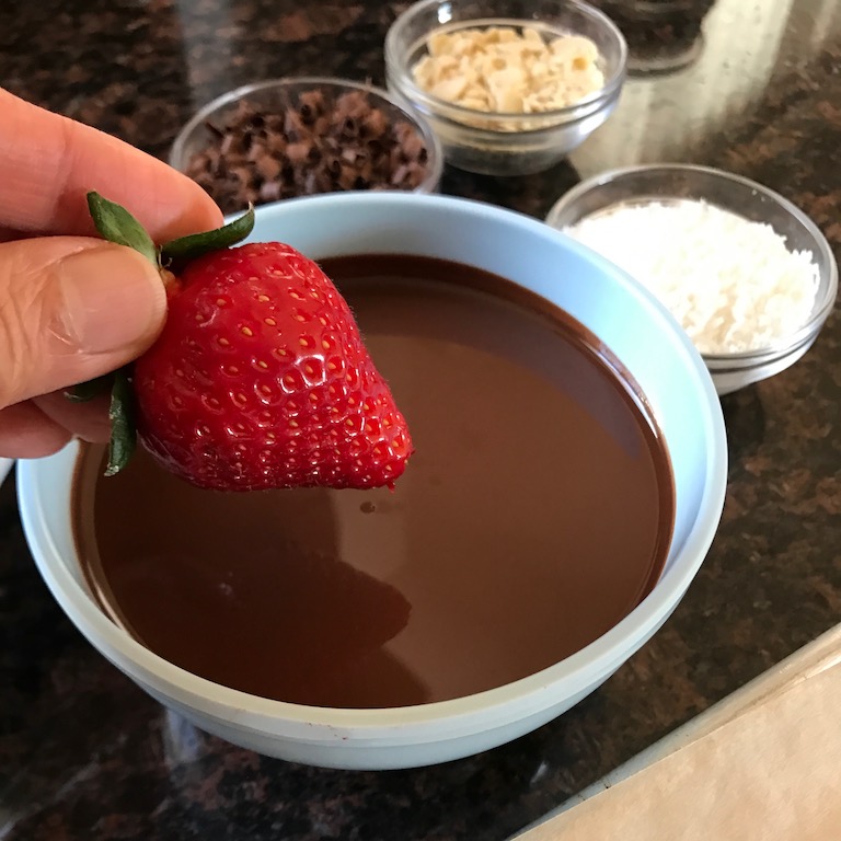Dipping strawberry in the chocolate