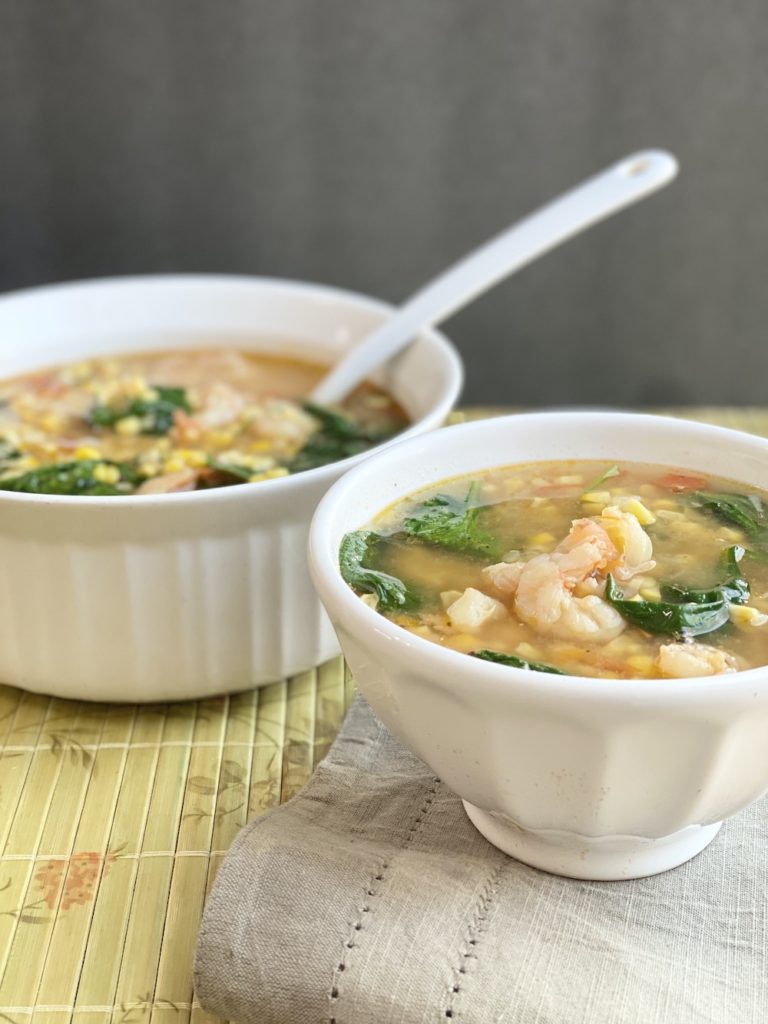 corn soup in the bowl with serving spoon