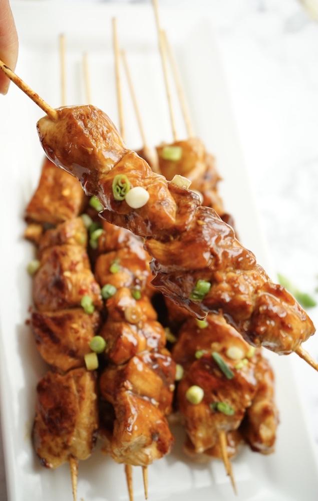 Chicken skewers on white plate