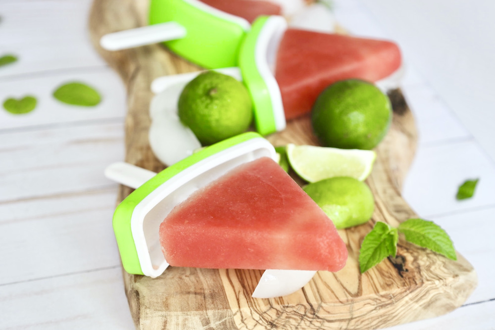 watermelon popsicles on a wooden cutting board