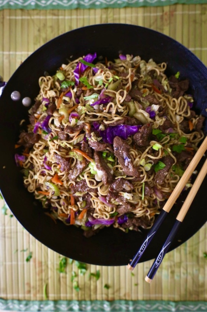 Beef Ramen Noodle Stir Fry in the wok with chop sticks vertical image