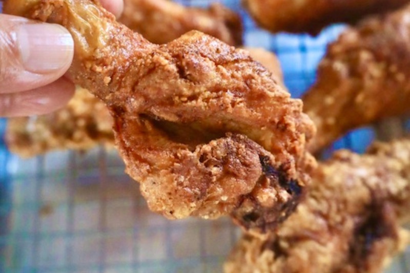 Crispy Fried Chicken holding the chicken