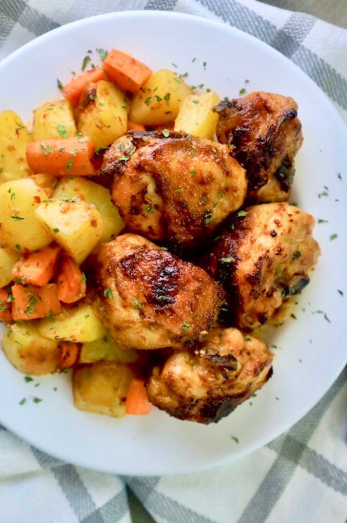 chicken with carrots and potatoes on a white plate